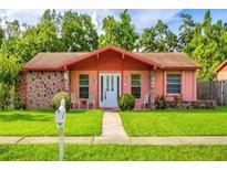 Charming single-story home featuring a well-manicured lawn, stone accents, and inviting front porch at 2202 Whitney Pl, Valrico, FL 33594