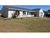 Charming single-story home with a well-maintained lawn and white-trimmed windows at 5052 Trekell St, North Port, FL 34287