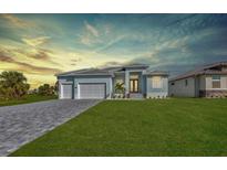 Beautiful single-story home with a well-manicured lawn, double garage, and a neatly paved driveway at 261 Rotonda S Blvd, Rotonda West, FL 33947