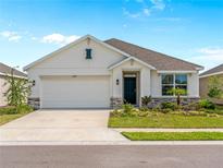 Charming single-story home featuring a two-car garage, inviting front entrance, and beautifully landscaped front yard at 17737 Canopy Pl, Bradenton, FL 34211