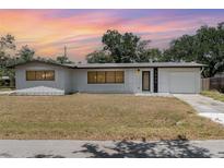 Charming single-story home with a well-maintained lawn and an attached single car garage at 2239 Worrington St, Sarasota, FL 34231
