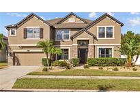 Beautiful two-story home with a well-manicured lawn and a welcoming front entrance at 11818 Gilmerton Dr, Riverview, FL 33579