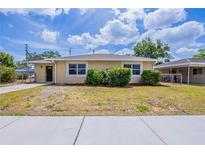 Charming single-story home with a well-maintained lawn and welcoming curb appeal at 1409 N Garden Ave, Clearwater, FL 33755
