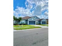 Beautiful exterior showcasing well-manicured lawn, two garages, and appealing curb appeal at 30442 Lettingwell Cir, Wesley Chapel, FL 33543
