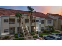 Multi-unit building with red tile roof, palm trees, and parking area, providing convenient access to homes at 6131 Bahia Del Mar Blvd # 139, St Petersburg, FL 33715
