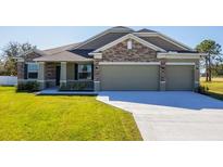 Charming single-story home featuring a three-car garage and well-maintained lawn at 6179 Notre Dame Ter, North Port, FL 34291