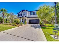 Beautiful two-story home featuring manicured landscaping and a wide driveway at 5703 New Paris Way, Ellenton, FL 34222