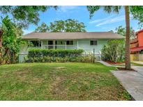 Charming single-story home featuring lush landscaping and a welcoming front porch in a serene setting at 9503 Alice Ln, Riverview, FL 33578