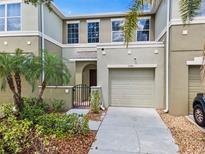 Attractive townhouse featuring a private courtyard with gate, and a one car garage at 2943 Willowleaf Ln, Wesley Chapel, FL 33544