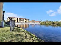 Scenic community view featuring a pond, fountain, and well-maintained buildings against a blue sky at 4333 Bayside Village Dr # 310, Tampa, FL 33615