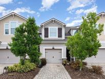 Charming townhome showcasing a well-maintained front yard and attached garage at 12232 Trailhead Dr, Bradenton, FL 34211