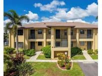Well-maintained two story condo building with landscaped front yard and covered entryways and balconies at 3221 White Ibis Ct # C1, Punta Gorda, FL 33950