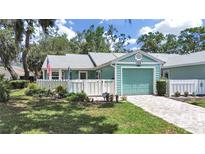 Charming single-story home with a lovely fenced yard and a one-car garage at 12519 Knollbrook Ln, Hudson, FL 34669