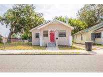 Charming single-story home with stone accents, a red front door, and a well-maintained yard at 1424 14Th S St, St Petersburg, FL 33705
