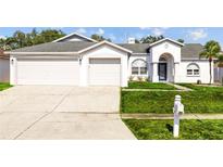 Charming single-story home featuring a well-manicured lawn and an attached three-car garage at 709 Tuscanny St, Brandon, FL 33511