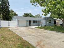 Charming single-story home with a long driveway and a white picket fence for added curb appeal at 8399 78Th N Ave, Seminole, FL 33777
