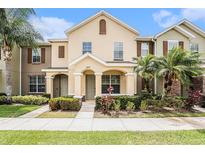 Charming townhome featuring manicured landscaping and a welcoming covered entrance at 14174 Oakham St, Tampa, FL 33626