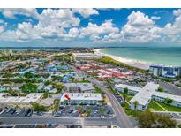 Breathtaking aerial view of a beachfront apartment complex with stunning ocean views and cityscapes at 680 71St Ave # 9, St Pete Beach, FL 33706