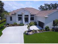 Stunning home features a well-manicured lawn, beautiful landscaping, and a spacious driveway at 608 Bittner Blvd, Nokomis, FL 34275