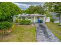 Charming single-story home featuring a well-maintained lawn and driveway at 5651 Kelly N Dr, St Petersburg, FL 33703
