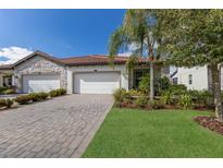 Charming home featuring a three car garage, paver driveway, manicured lawn and mature landscaping at 2532 Avolet Ct, Lakewood Ranch, FL 34211