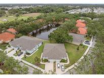 An aerial view of the community with water feature, landscaping, and residences with driveways at 146 51St Street E Cir, Palmetto, FL 34221