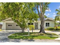 Charming single-story home with an attached garage and beautiful mature trees in a desirable neighborhood at 2302 16 W St, Palmetto, FL 34221