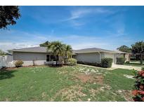 Charming single-story home featuring a well-maintained lawn and mature landscaping under a bright blue sky at 9497 122Nd Way, Seminole, FL 33772