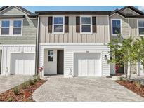 Charming townhouse with a brick paver driveway and a one-car garage, enhancing curb appeal at 7288 Deer Valley Circle, Tampa, FL 33635