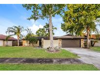 Charming single-story home with stone accents, mature trees, and a well-manicured lawn at 2006 Sycamore Ln, Plant City, FL 33563