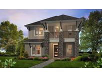 A modern two-story home boasts stone accents, a balcony, and a well-manicured lawn at 28875 Seedling St, Wesley Chapel, FL 33543