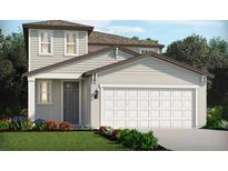 Charming two-story home featuring an attached two-car garage and well-manicured landscaping at 14076 Crutchfield Ct, Parrish, FL 34219