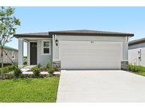 Charming single-story home featuring a two-car garage, well-maintained lawn, and inviting front entrance at 14115 Crutchfield Ct, Parrish, FL 34219