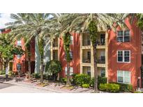 A view of the exterior showing multi-story building with balconies and mature palm trees at 2411 W Horatio St # 537, Tampa, FL 33609