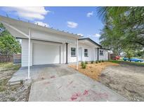 Charming single-story home featuring a driveway with carport and manicured landscaping enhancing its curb appeal at 4119 Beacon Square Dr, Holiday, FL 34691