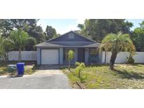 Charming single-story home featuring a classic gable roof and a cozy front porch bench at 3607 Johnson Ct, Palm Harbor, FL 34684
