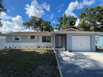 Charming single-story home featuring a manicured lawn, fresh landscaping, and a one car garage at 9153 86Th Ave, Seminole, FL 33777