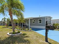 Charming single-story home featuring a well-manicured lawn, tasteful landscaping, and a freshly painted exterior at 5141 Oakland Hills Ave, Sarasota, FL 34234