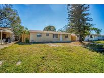 Charming single-story home with a lush green lawn and a freshly painted exterior at 6940 82Nd N Ave, Pinellas Park, FL 33781