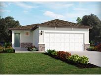 Charming single story home featuring a two car garage, stone veneer accents, and well manicured lawn at 1828 Brekey Way, Zephyrhills, FL 33541