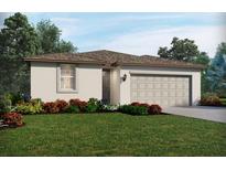 Charming single-story home with a two-car garage, manicured lawn, and tasteful landscaping at 31628 Wild Grape Ln, Brooksville, FL 34602