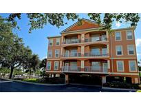 Three-story condominium building with balconies and covered parking at 5000 Culbreath Key Way # 9-101, Tampa, FL 33611