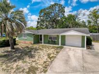 Charming single-story home with a well-maintained lawn and attached one car garage in a beautiful neighborhood at 5415 Riddle Rd, Holiday, FL 34690