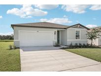 Charming single-story home featuring a spacious driveway and manicured front lawn at 7728 Gilchrist Springs Dr, Parrish, FL 34219
