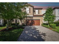 Charming two-story home featuring a paved driveway and a well-maintained front yard at 13083 Burns Dr, Odessa, FL 33556