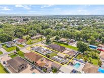 Wide aerial shot captures a home with a lovely neighborhood, showcasing the property's setting and community at 10227 Parsons St, Tampa, FL 33615