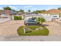 Charming single-story home featuring a brick paved driveway and mature landscaping at 10227 Parsons St, Tampa, FL 33615