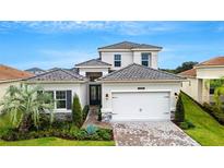 Beautiful two-story home with landscaped front yard and brick paver driveway at 32740 Tree Of Life Ave, Wesley Chapel, FL 33543