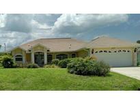 Charming single-story home with well-maintained lawn and attached two-car garage at 4875 Hansard Ave, North Port, FL 34286