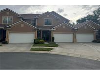 Charming townhome featuring a multi-car garage and neutral-colored exterior at 1212 Georgia Trace Ave, Valrico, FL 33596